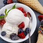 Vanilla ice cream with fresh frozen berries raspberries, blueberries and blackberries